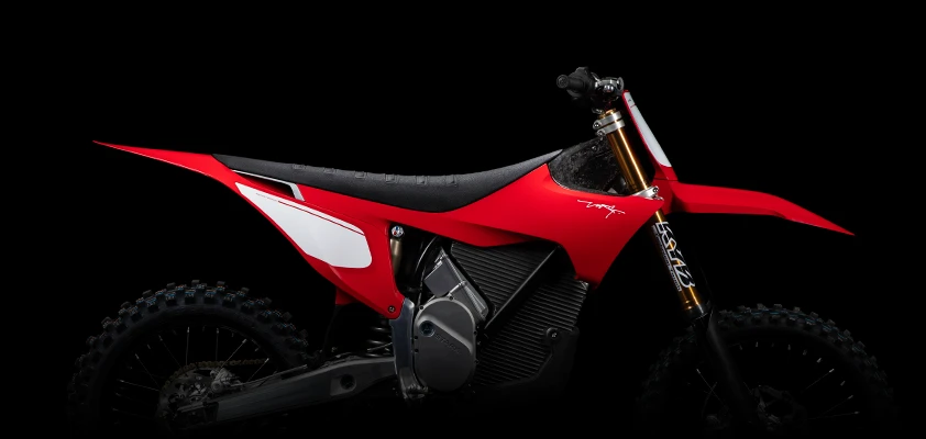 Stark VARG Factory Edition in Factory Red — full right-side studio profile of the 80hp ALPHA electric motocross bike with KYB Kashima gold forks