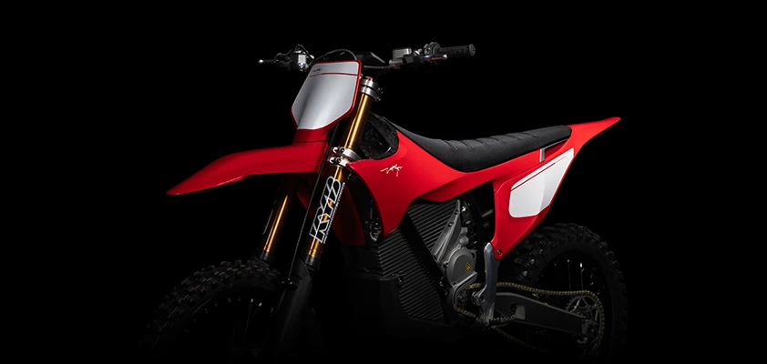 Front three-quarter angle of the Stark VARG Factory Edition with KYB Kashima gold forks and Factory Red bodywork — electric motocross front-end detail