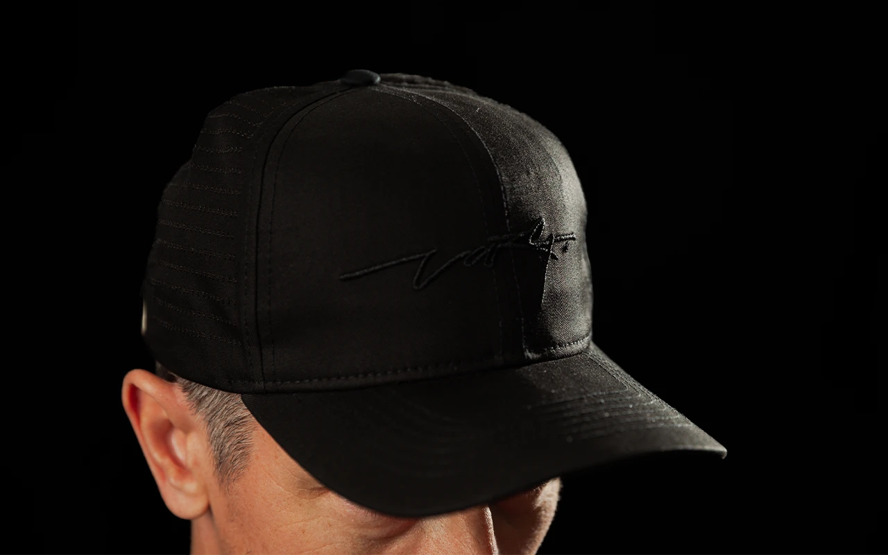 Front three-quarter view of a man wearing the black Stark Future jute cap, showing the front panel and peak.