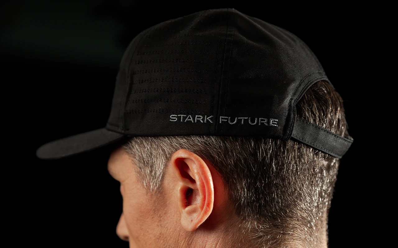 Side view of a man wearing the black Stark Future jute cap, showing the curved peak and STARK FUTURE on the band.