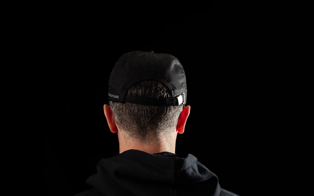 Rear view of a man wearing the black Stark Future jute cap, showing the strap at the back.